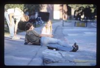 Students relaxing on a curb
